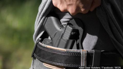A gun being carried concealed in an inside the waistband holster